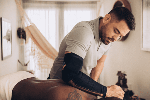 <img src="your-image-file.jpg" alt="Trust Technique in action with the ExoArm infrared sleeve, demonstrating its effectiveness in massage therapy courses to enhance healing and skill development.">